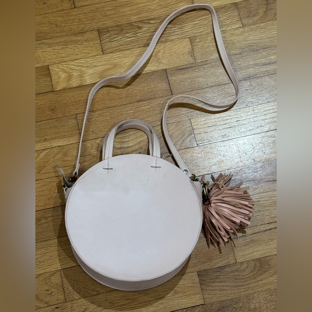 Clare V. Chic pink Cream Circle Crossbody leather Bag with bag charm. EUC